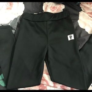 Black leggings with a cat logo